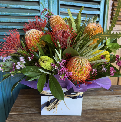 Country Christmas - Best quality Australian native and wildflowers will be used in this long lasting arrangement for you.
Banksia, Pincushions, Wax flowers, Coccinias,